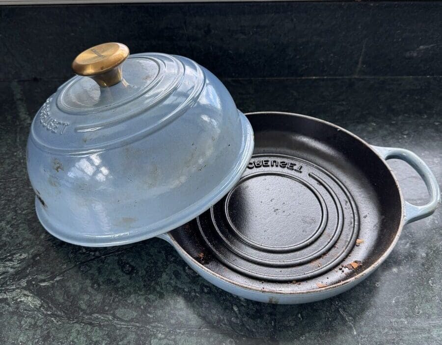 Image of a light blue Le Creuset cast iron bread oven, shown with the lid off.