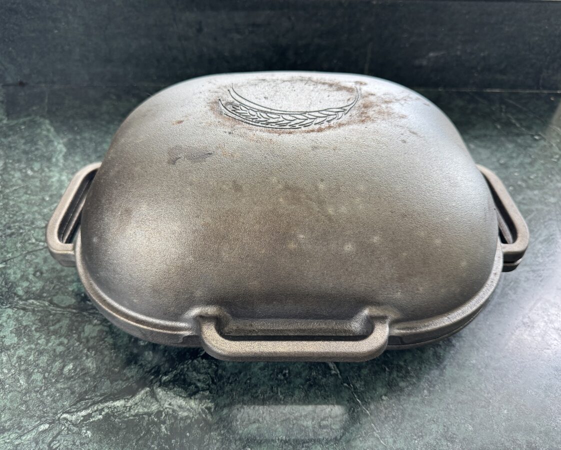 Image of the Challenger Bread Pan on a green marble countertop.