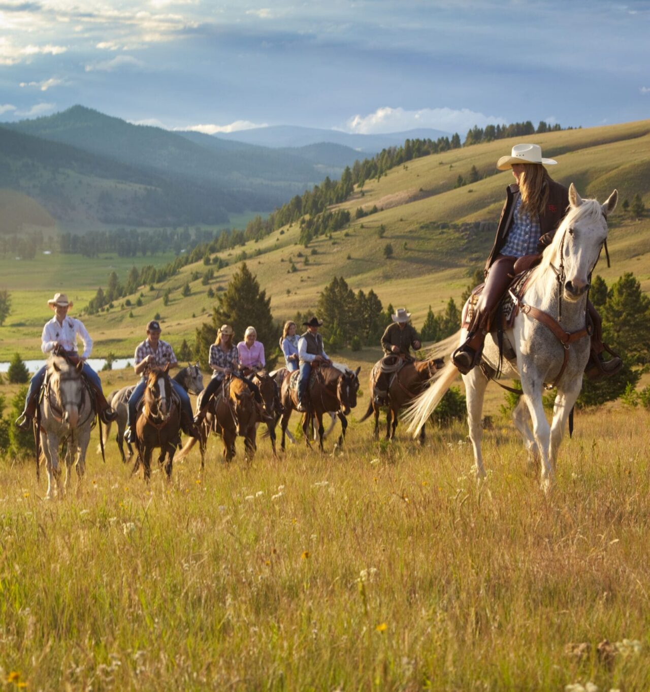 Image of a horseback riding guide leading a group of riders on horseback.