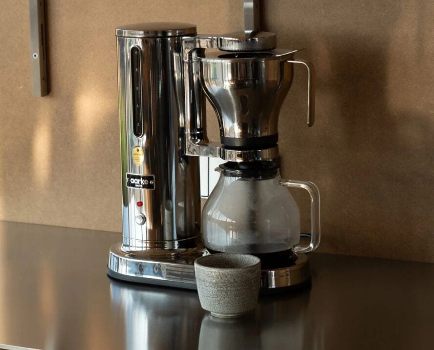 Image of the Aarke Coffee Maker in stainless steel, shown in an industrial kitchen.