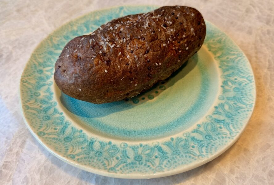 Image of an air fryer baked potato with a brown crispy skin.