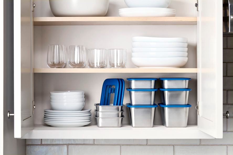 Image of several Misenware containers in various sizes, stacked on a shelf in a cupboard.