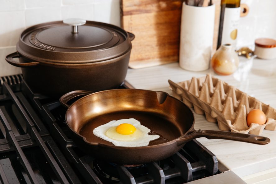 Image of a Made In cast iron skillet being used to fry an egg on a stovetop.