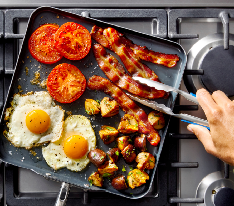 Image of the Misen Carbon Nonstick square griddle being used to fry up a full breakfast spread.
